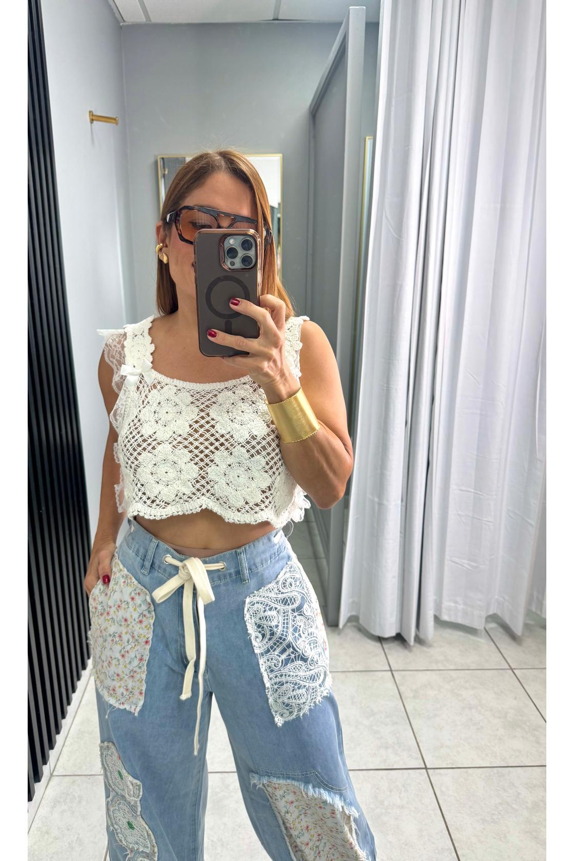 Designed in relaxed fit pants in denim with floral patch detail.