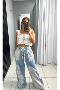 Designed in relaxed fit pants in denim with floral patch detail.