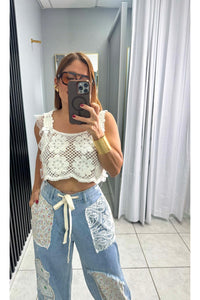 Designed in relaxed fit pants in denim with floral patch detail.