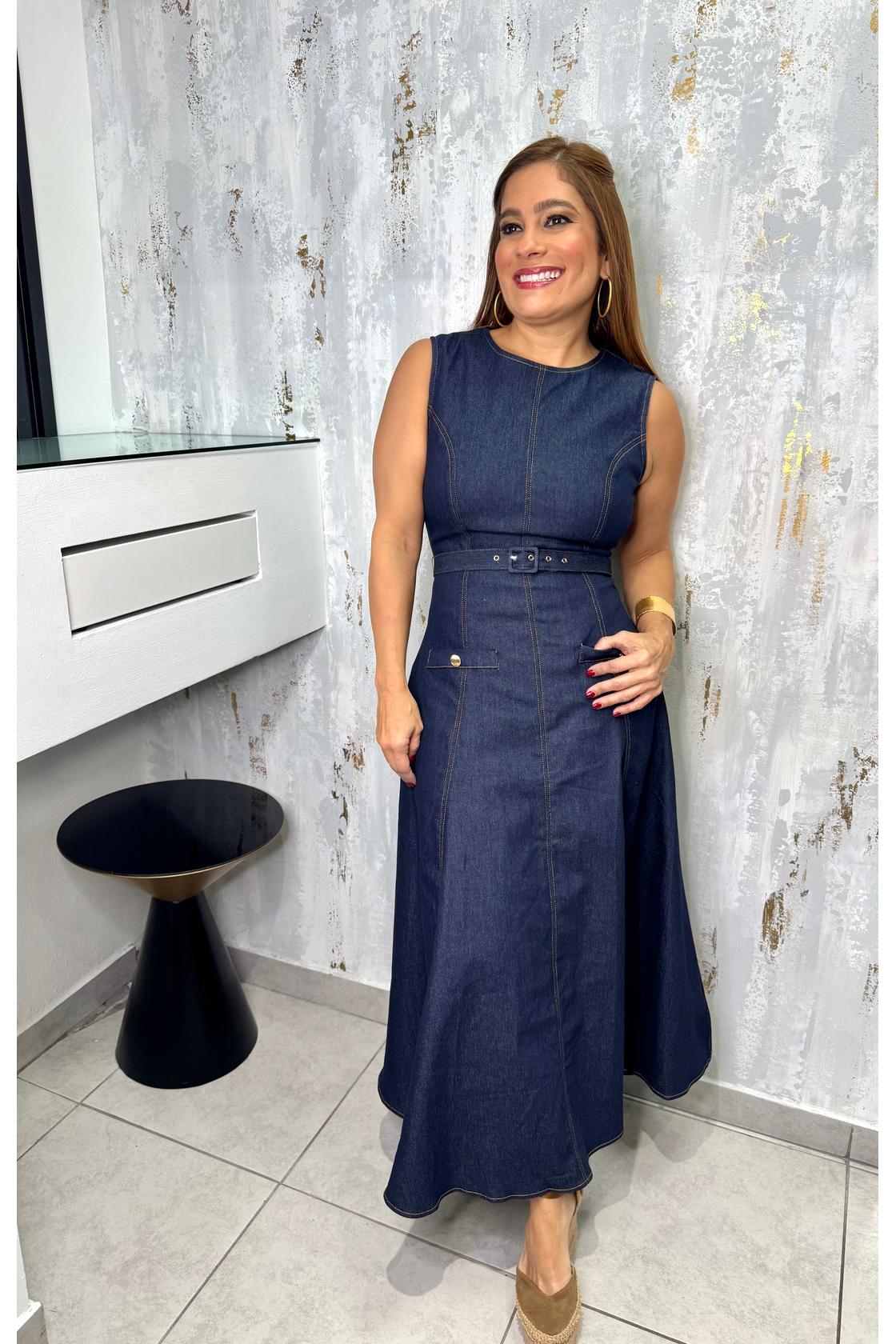 Leticia  denim midi dress featuring round neckline, sleeveless, self belt, circle skirt and back zipper closure