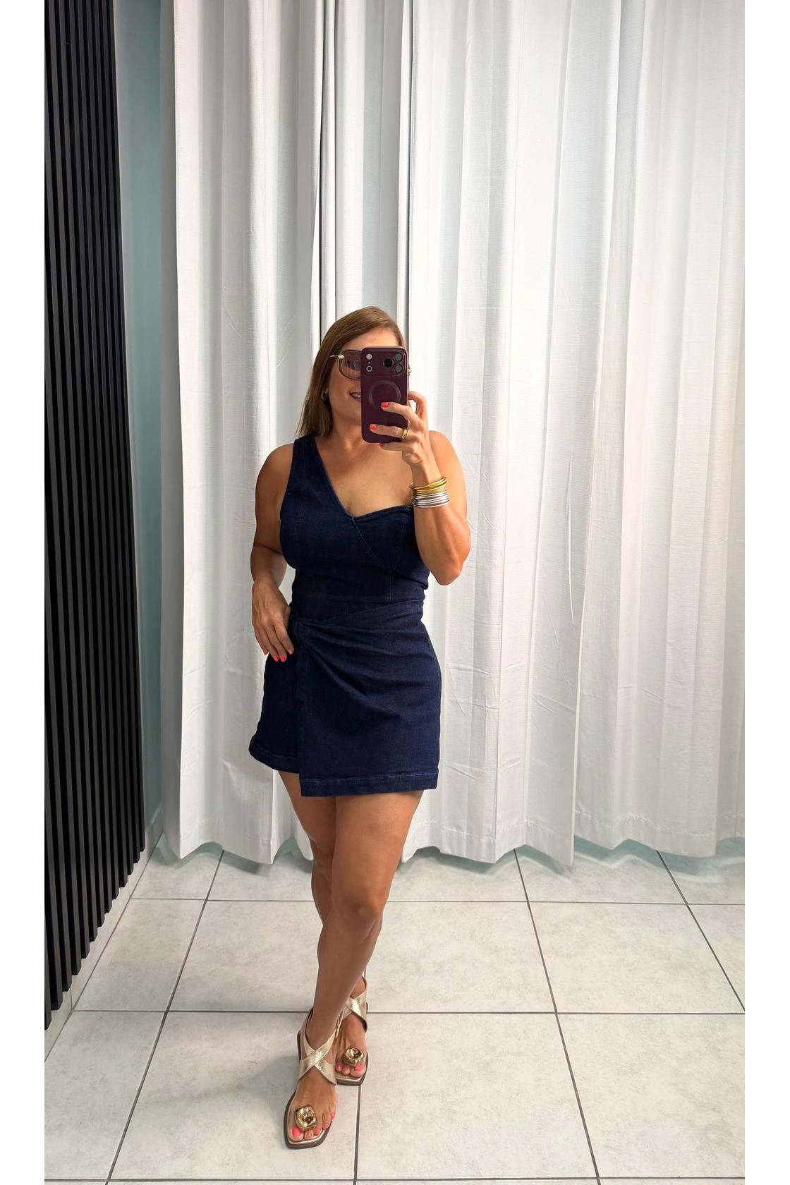 Denim skort romper featuring one shoulder neckline, front twist bottom and back zipper closure